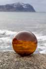 Norway- Lofoten Islands- Vareid. Mountains and ocean viewed through a glass ball Art Print